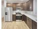 Well-equipped kitchen with stainless steel appliances, solid surface countertops, and wood cabinets at 6847 Cardiff Dr, McCordsville, IN 46055