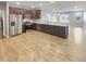 Modern kitchen featuring stainless steel appliances, dark cabinets, and hardwood floors at 6847 Cardiff Dr, McCordsville, IN 46055