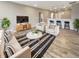 An inviting living room featuring modern furniture, sleek barstools, and hardwood floors at 6847 Cardiff Dr, McCordsville, IN 46055