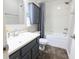 Clean and updated bathroom featuring white tile, a bathtub with shower, and a modern vanity at 7155 Sea Pine Dr, Indianapolis, IN 46250