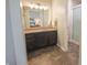 Modern bathroom featuring dark cabinetry, a shower, and a view into the Primary bedroom at 7155 Sea Pine Dr, Indianapolis, IN 46250