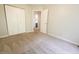 Bedroom with plush carpeting, white closet doors, and a view into the ensuite bathroom at 7155 Sea Pine Dr, Indianapolis, IN 46250
