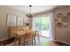 Bright dining room with modern decor, wooden table, stylish chairs, and sliding glass doors to outdoor space at 7155 Sea Pine Dr, Indianapolis, IN 46250