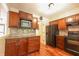 Modern kitchen with stainless steel appliances, granite countertops, and wood cabinetry at 7155 Sea Pine Dr, Indianapolis, IN 46250