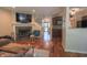 Cozy living room showcasing a fireplace, wood floors, and staircase access at 7155 Sea Pine Dr, Indianapolis, IN 46250
