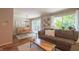 Inviting living room area with dining space, large windows and a comfortable sofa at 7155 Sea Pine Dr, Indianapolis, IN 46250