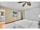 Clean bedroom with hardwood floors, a ceiling fan, and ensuite bathroom access at 7316 Lesley Ave, Indianapolis, IN 46250
