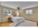Bright bedroom with large windows, ceiling fan, and hardwood flooring at 7316 Lesley Ave, Indianapolis, IN 46250