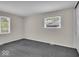 This bedroom features neutral walls, carpet floors, and windows providing natural light at 7316 Lesley Ave, Indianapolis, IN 46250