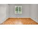 Neutral bedroom with hardwood parquet floors and a bright window at 7316 Lesley Ave, Indianapolis, IN 46250