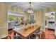 Elegant dining room with stylish lighting, a large table, and a view into the living room at 7316 Lesley Ave, Indianapolis, IN 46250