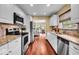 Spacious kitchen boasts stainless steel appliances and granite countertops at 7316 Lesley Ave, Indianapolis, IN 46250
