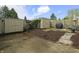 Backyard with mulch, two storage units, fence, grill and table with chairs at 7334 Country Brook Dr, Indianapolis, IN 46260