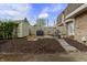 Backyard with mulch, storage unit, fence, grill and table with chairs at 7334 Country Brook Dr, Indianapolis, IN 46260