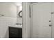 Bathroom featuring vanity with mirror, white tiling, and lighting at 7334 Country Brook Dr, Indianapolis, IN 46260