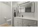 Clean bathroom with white vanity, large mirror, and neutral tile flooring at 7334 Country Brook Dr, Indianapolis, IN 46260