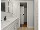 Bathroom featuring white vanity, and a door leading to an adjacent laundry room at 7334 Country Brook Dr, Indianapolis, IN 46260