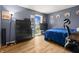 Cozy bedroom features hardwood floors, ample natural light, and modern decor at 7334 Country Brook Dr, Indianapolis, IN 46260