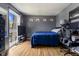 Bedroom with hardwood flooring, large window, a TV, desk, and modern decor at 7334 Country Brook Dr, Indianapolis, IN 46260