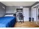 Bedroom with wood floors, desk, and sliding closet doors at 7334 Country Brook Dr, Indianapolis, IN 46260