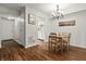 Inviting dining area with hardwood floors, chandelier, and doorway to kitchen at 7334 Country Brook Dr, Indianapolis, IN 46260