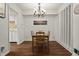 Dining room with hardwood flooring, elegant chandelier, and dining table at 7334 Country Brook Dr, Indianapolis, IN 46260