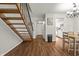 Bright entryway with wooden staircase, dining area, and white kitchen in the background at 7334 Country Brook Dr, Indianapolis, IN 46260