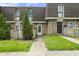Charming townhome featuring brick facade, well-manicured lawn, and inviting entryway with tree at 7334 Country Brook Dr, Indianapolis, IN 46260