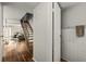 Bright interior view highlighting staircase with hardwood floors, and bathroom entrance at 7334 Country Brook Dr, Indianapolis, IN 46260