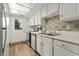 Charming kitchen with white cabinets, stainless steel appliances, and a windowed door to the outside at 7334 Country Brook Dr, Indianapolis, IN 46260