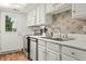 Modern kitchen featuring stainless steel appliances, white cabinets, and a door that leads to the backyard at 7334 Country Brook Dr, Indianapolis, IN 46260