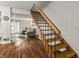 Interior view showcasing staircase with open living room featuring hardwood floors at 7334 Country Brook Dr, Indianapolis, IN 46260