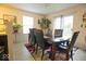 A dining room with a dark wood dining table and chairs, next to a window and glass patio door at 7737 Wolfgang Pl, Indianapolis, IN 46239