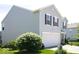 Exterior view of the two-story home featuring vinyl siding, and an attached two car garage at 7737 Wolfgang Pl, Indianapolis, IN 46239