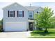 Charming two-story home featuring a well-manicured lawn and attached two car garage at 7737 Wolfgang Pl, Indianapolis, IN 46239