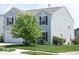 Charming two-story home with a well-manicured lawn and mature landscaping at 7737 Wolfgang Pl, Indianapolis, IN 46239