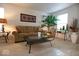 Comfortable living room with neutral carpet, featuring a glass top coffee table and house plants at 7737 Wolfgang Pl, Indianapolis, IN 46239