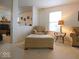 Living area offering a cozy reading nook with a neutral armchair and ottoman at 7737 Wolfgang Pl, Indianapolis, IN 46239