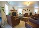 Open concept living room with a cozy stone fireplace and comfortable seating at 7737 Wolfgang Pl, Indianapolis, IN 46239