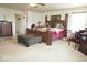 Spacious main bedroom with a king bed, dark wood furniture, sitting area and multiple windows at 7737 Wolfgang Pl, Indianapolis, IN 46239