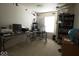 Functional office space with dual monitors, overhead aircraft models, and built-in bookshelves at 7737 Wolfgang Pl, Indianapolis, IN 46239
