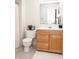 Bathroom with wood vanity, white countertop, and tiled floors at 8317 Pine Branch Ln, Indianapolis, IN 46234