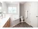 Bathroom featuring a soaking tub, a wooden vanity with sink, and a toilet at 8317 Pine Branch Ln, Indianapolis, IN 46234