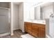 Bathroom features a glass enclosed shower, a double vanity with wood cabinets, and wood-look floors at 8317 Pine Branch Ln, Indianapolis, IN 46234