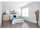 Bedroom with wood floors, and a large window providing natural light at 8317 Pine Branch Ln, Indianapolis, IN 46234