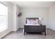 Bright bedroom with hardwood floors, decorative pillows, and a large window providing ample natural light at 8317 Pine Branch Ln, Indianapolis, IN 46234