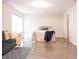 Bright bedroom features contemporary design, a large window, wood-look floors, and a door to the closet at 8317 Pine Branch Ln, Indianapolis, IN 46234