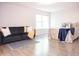 Bright bedroom features contemporary design, a large window, and wood-look floors at 8317 Pine Branch Ln, Indianapolis, IN 46234