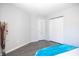 Bedroom featuring gray walls, wood-look floors, closet and paneled door at 8317 Pine Branch Ln, Indianapolis, IN 46234