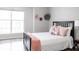Comfortable bedroom showcasing natural light, complemented by stylish bedding and decorative accents at 8317 Pine Branch Ln, Indianapolis, IN 46234